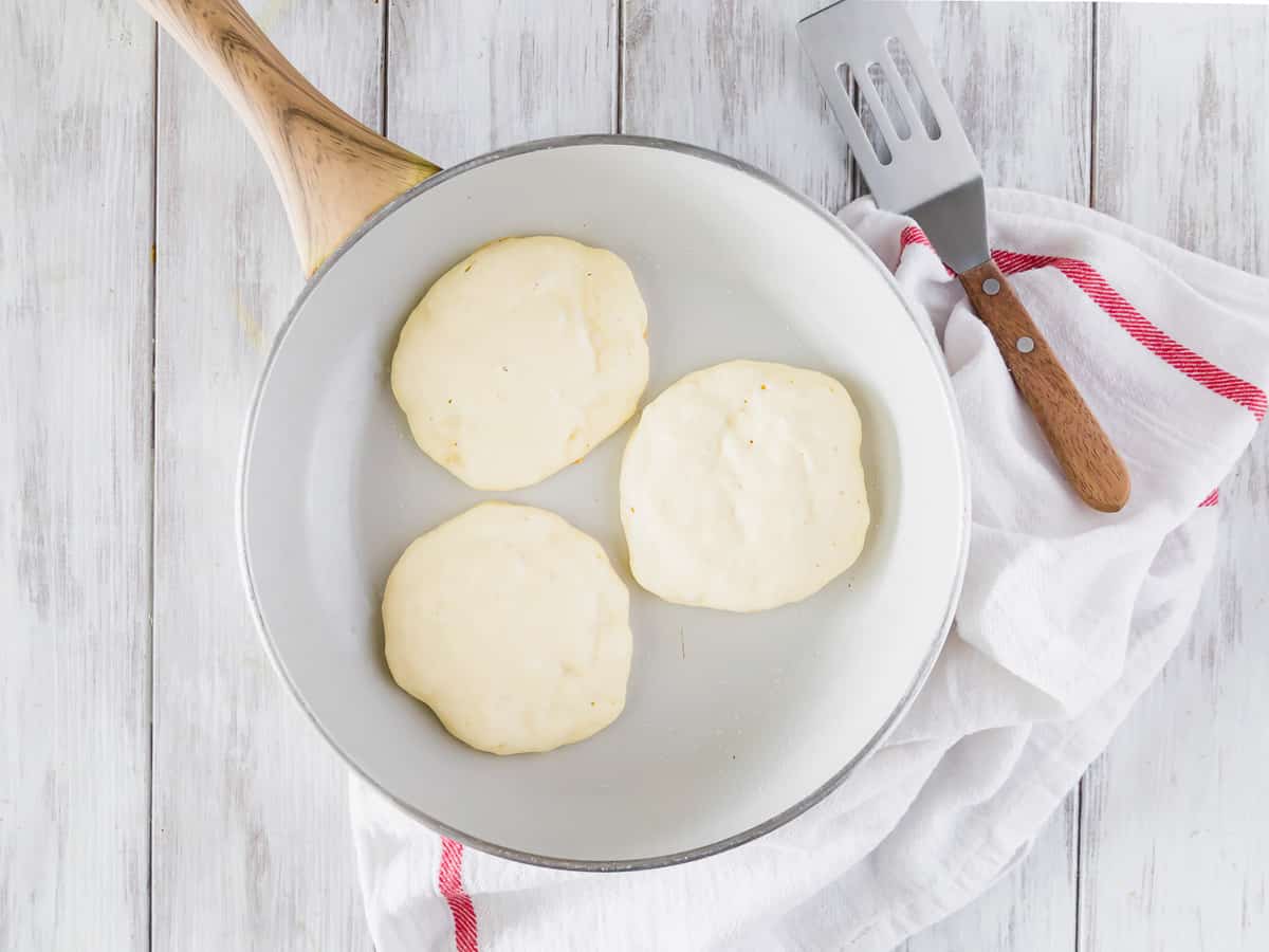 Pancakes à moitié cuits sur un gril.
