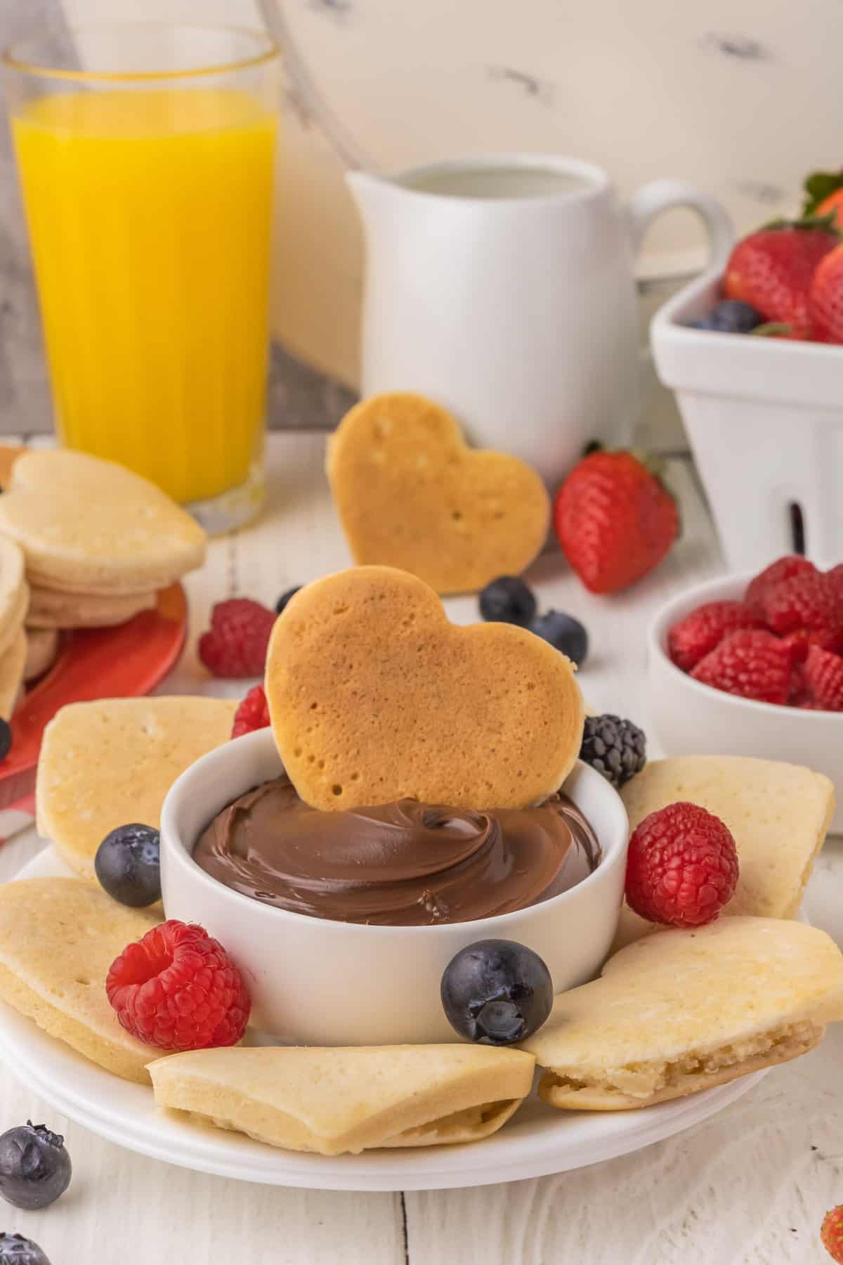 Pancake en forme de cœur trempé dans du nutella.