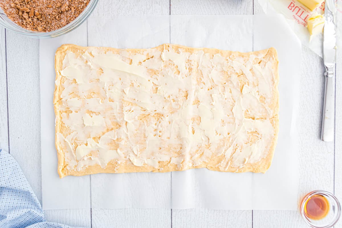 Rouleaux de pâte feuilletée étalés avec du beurre.