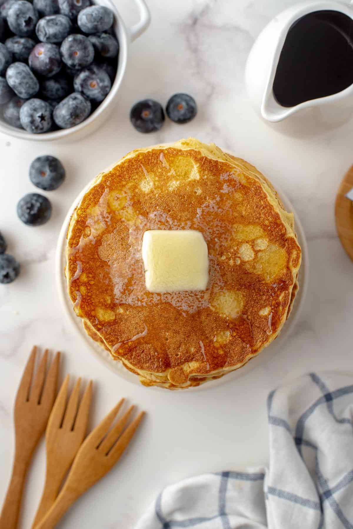 Vue de dessus de pancakes avec une noisette de beurre.