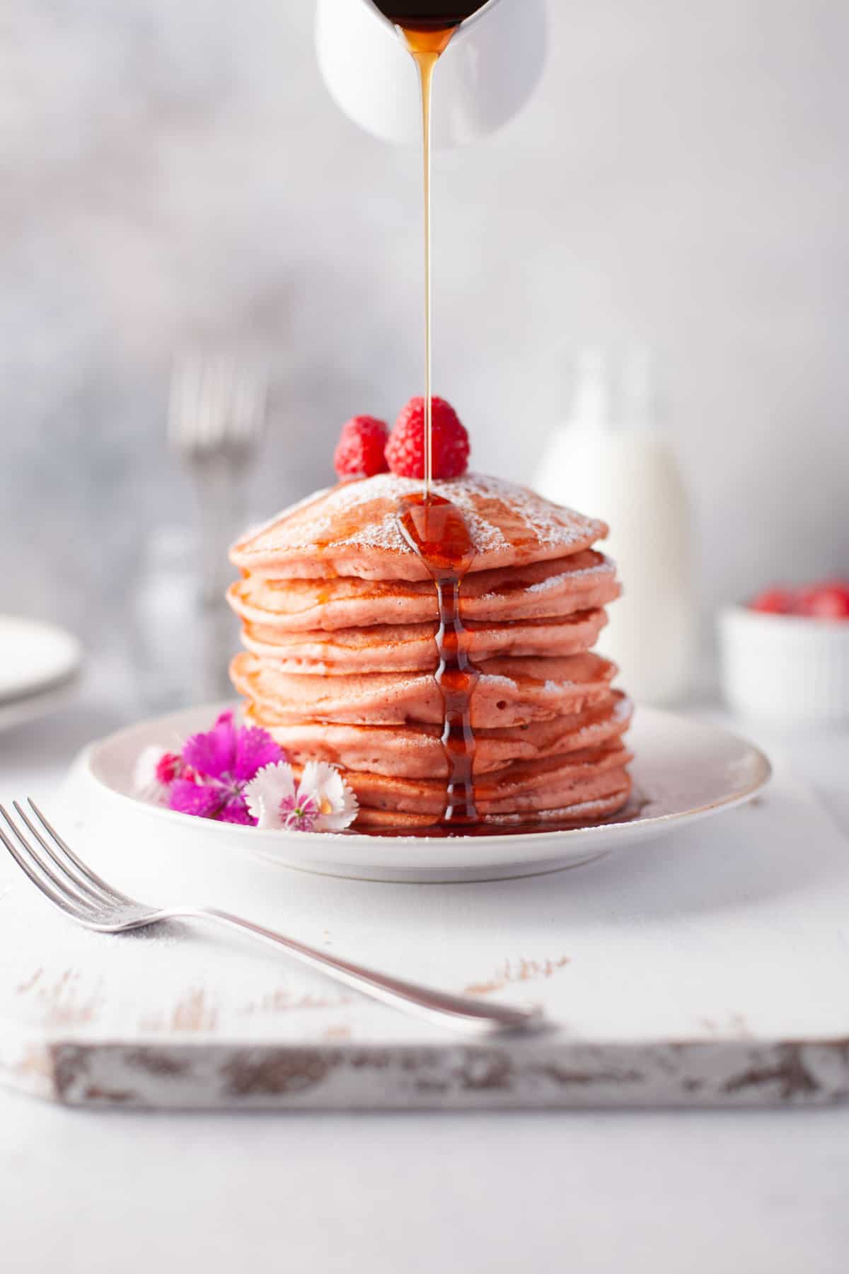 Sirop versé sur une pile de pancakes à la betterave.