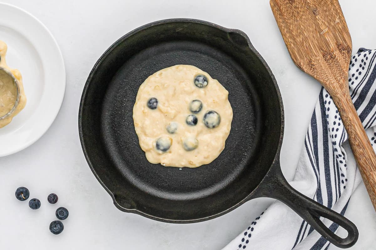 Pancake non cuit dans une poêle noire.